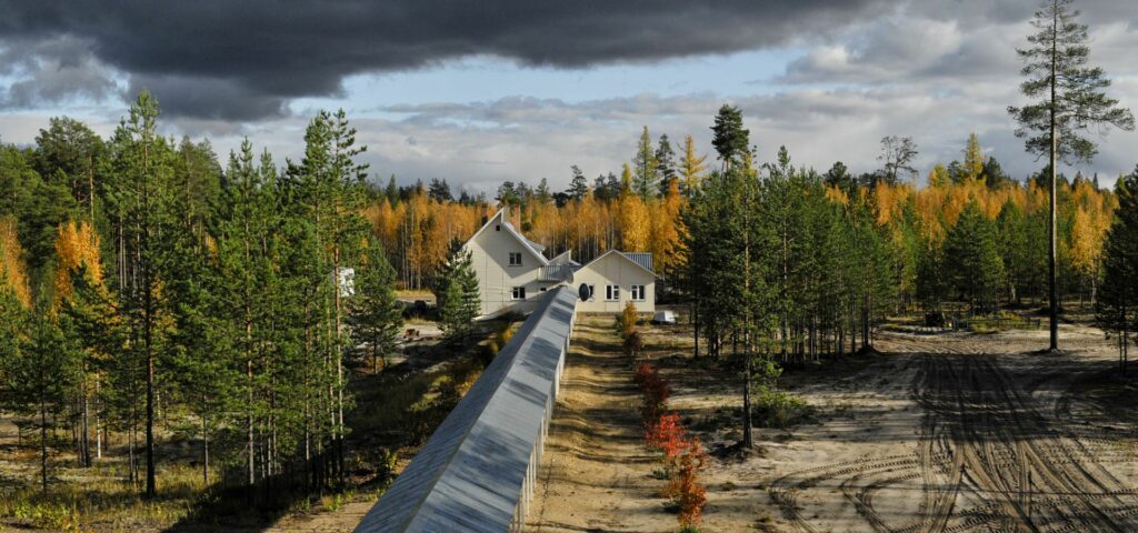 ZOTTO pergola leading to house and bunker in autumn with yellow birches in the back