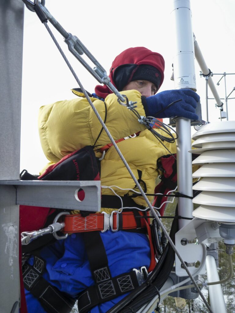 working person on eddytower in winter