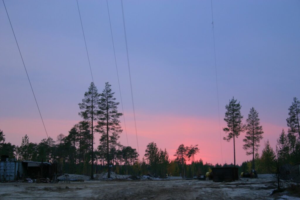 Tensioning cables of the tall tower before pink sky in Zotto