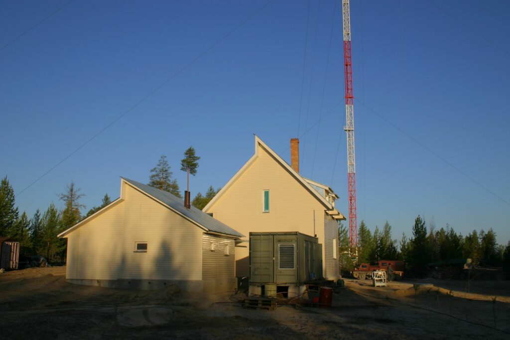 sunlit house next to the tower on a clear day