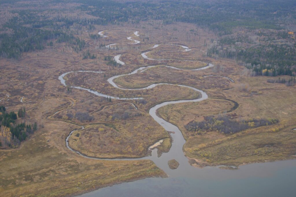 view from airplane on meandering tributary to the river Jenssei in autumn